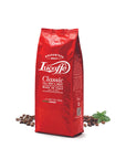 Red bag of Lucaffé Classic Italian coffee beans 1 kg with coffee beans and green leaves around it.