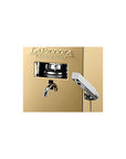 Close-up of La Piccola Gold espresso machine's brewing unit and steam wand in a sleek gold finish.